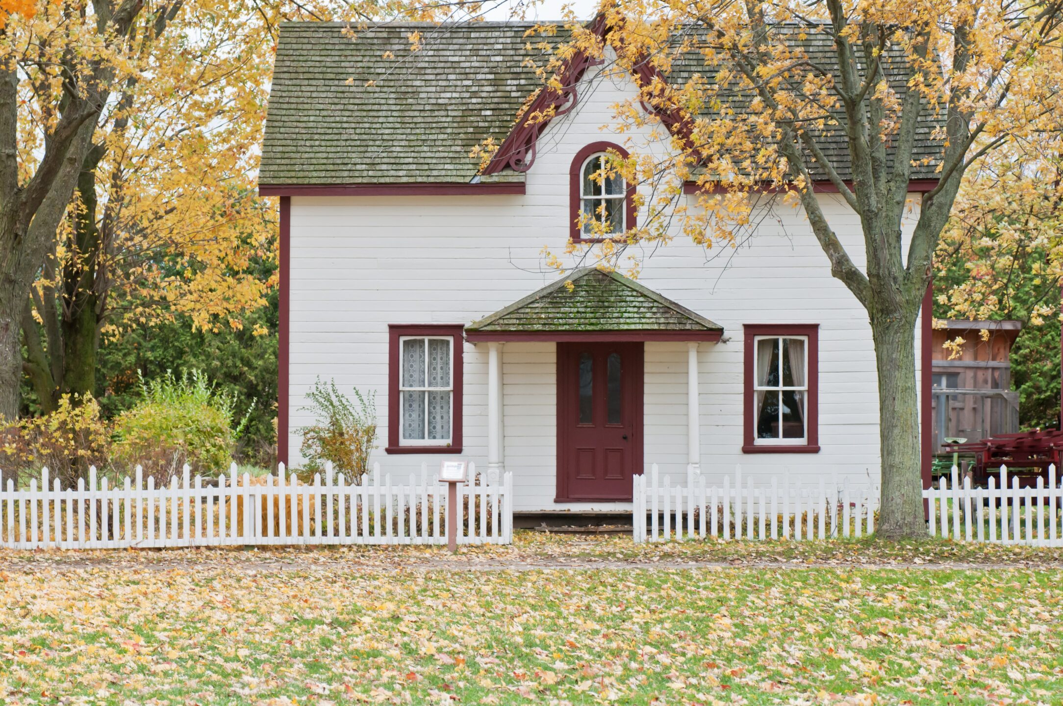 old white picket fence house representing a heritage property